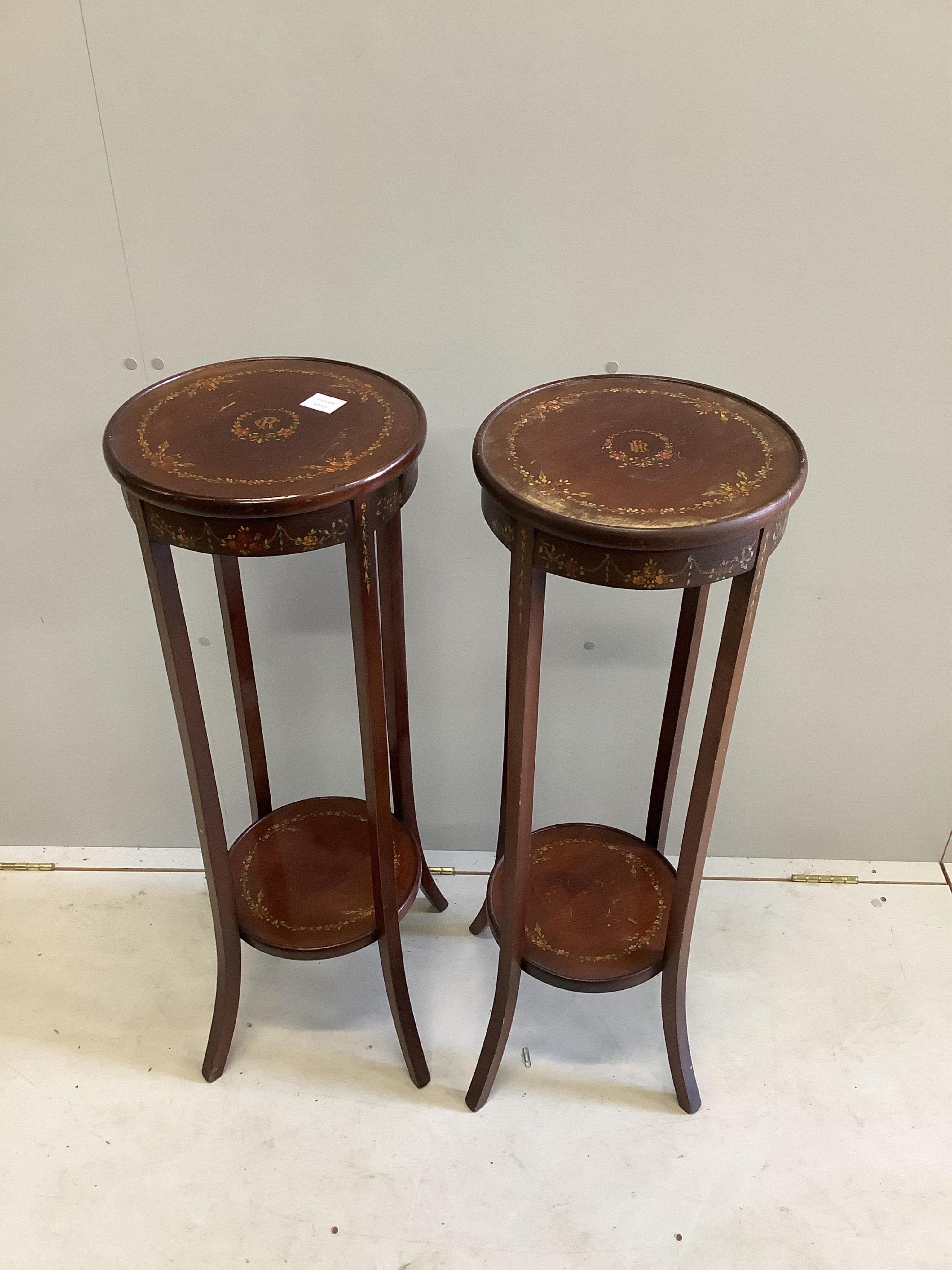 A pair of Sheraton Revival painted mahogany two tier plant stands, diameter 33cm, height 95cm. Condition - fair